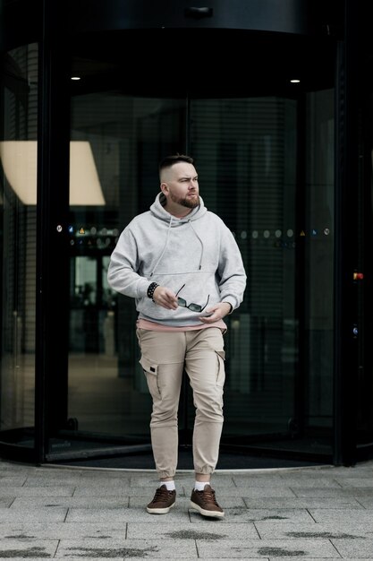 bearded hipster wears a gray hoodie