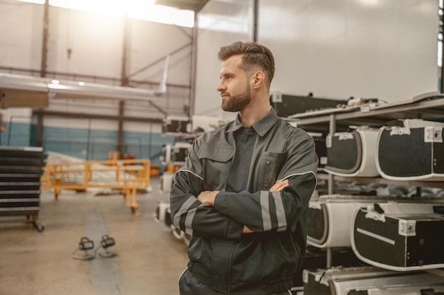 Bearded man airplane mechanic standing in hangar