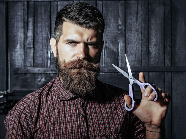 Bearded man barber with scissors