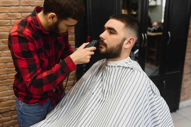 Bearded man, bearded male. Vintage barbershop, shaving. Portrait of stylish man beard. Barber scissors and straight razor, barber shop. Beard styling. Advertising barber shop concept. Black and white