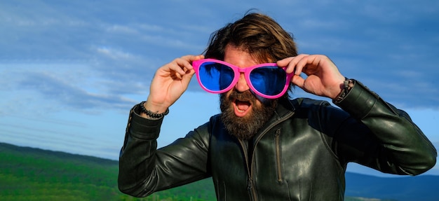 Bearded man in big glasses funny guy in big eyeglasses hipster in leather jacket and sunglasses