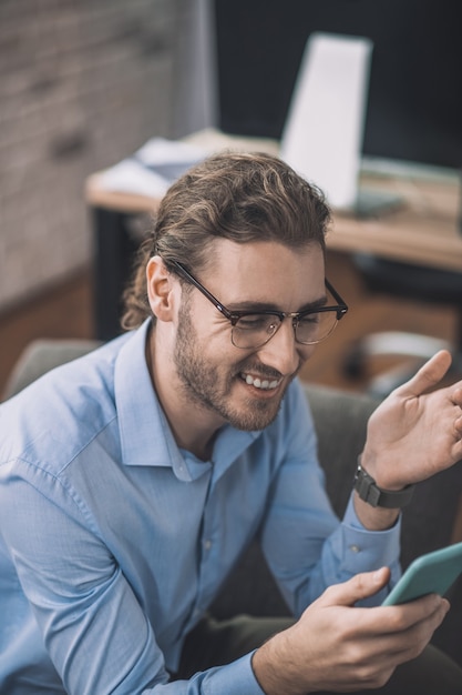 Bearded man in blue shirt having a video call