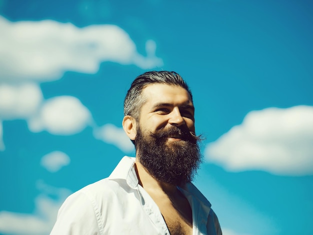 Bearded man on blue sky