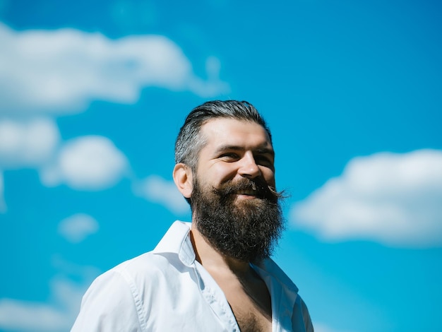 Bearded man on blue sky