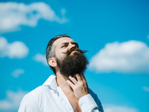 Bearded man on blue sky