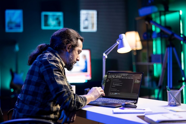 Bearded man coding on digital laptop