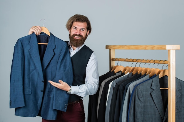 Bearded man collector vintage clothes showing formal suit\
famous brand concept