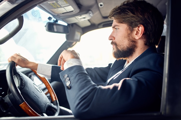 Bearded man driving a car trip luxury lifestyle service