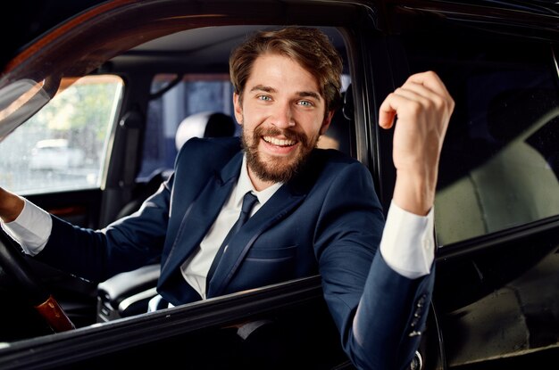 Bearded man driving a car trip luxury lifestyle success