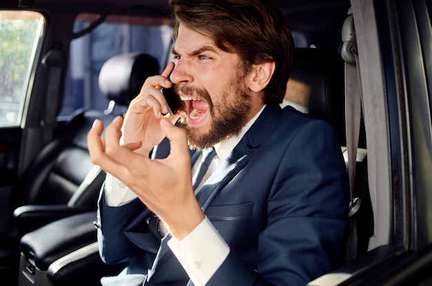 Bearded man driving a car trip luxury lifestyle success