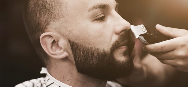 Bearded man getting beard haircut