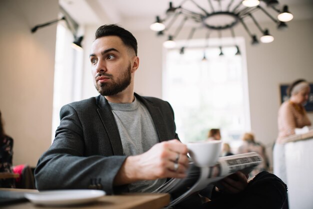 Bearded man having rest in cafe