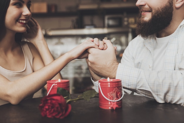 Bearded man hold the hand of a beautiful girl