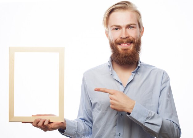 Bearded  man holding a picture frame