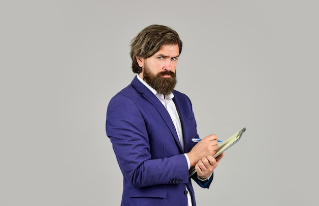 Bearded man making notes Supervising and controlling Project Curator Business people concept Businessman with folder Confident businessman holding folder for documents Control and inspection