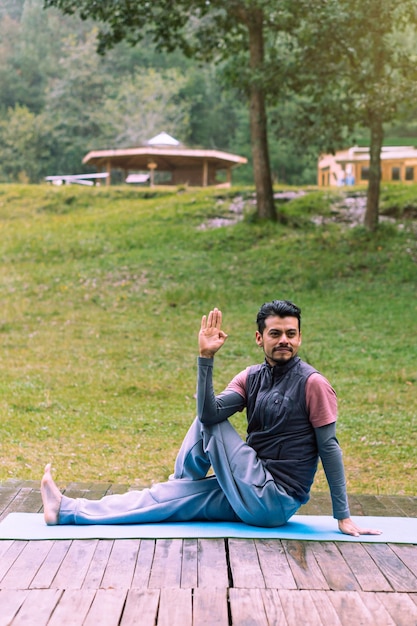 Bearded man performing yoga pose, mental health.