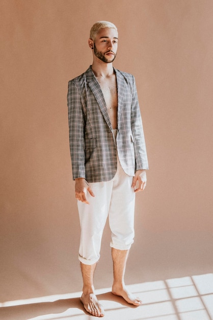 Bearded man in a plaid shirt and white pants