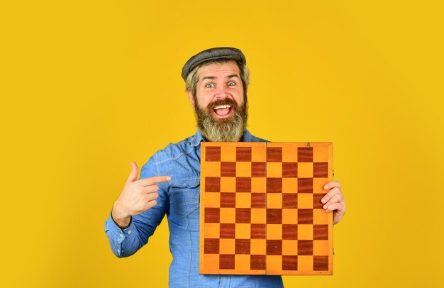 Bearded man play chess Chess figures Intellectual games Grandmaster experienced player Enjoy tournament Game strategy concept Chess lesson Cognitive development Chess competition Board game