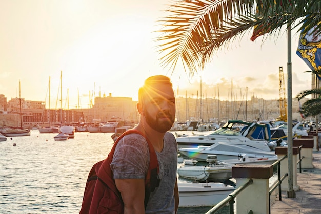 Bearded man portrait outdoor during golden hour time summer vacation vibes candid lifestyle