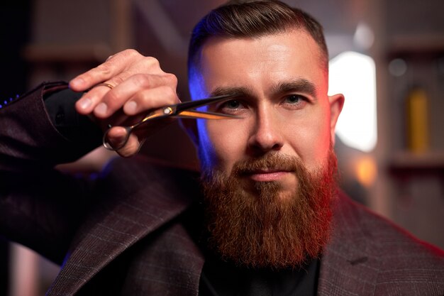 Bearded man posing in barber shop