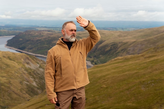 Bearded Man reaching the destination and on the top of mountain