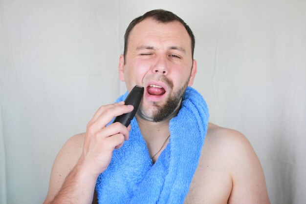 Bearded man shaving electric