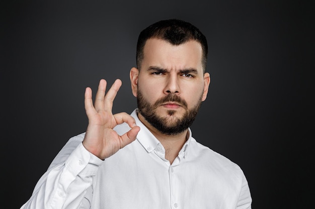 Bearded man showing Ok gesture