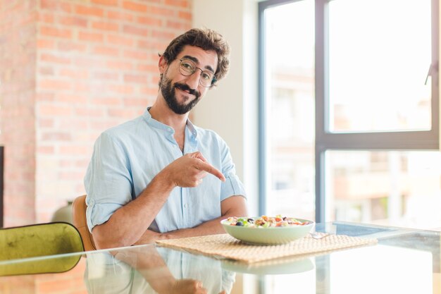 Bearded man smiling cheerfully, feeling happy