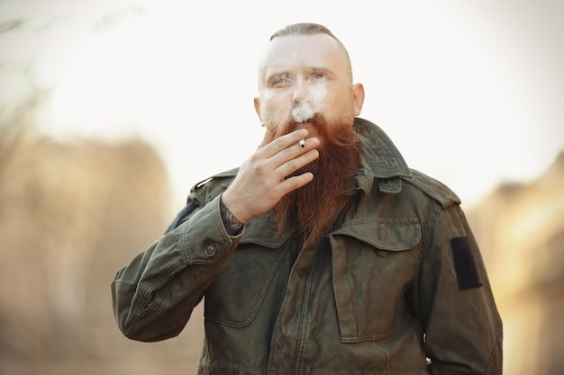 Bearded man smoking weed outdoors