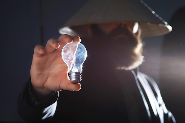 A bearded man in a suit holds an object in his hand. Concept of time and ideas. Aspiration and development.