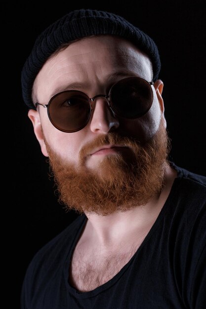 Bearded man in sunglasses and hat