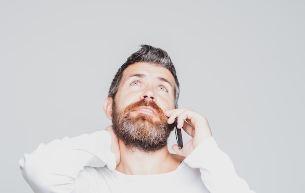 Bearded man talking on the phone Communications