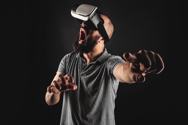 Bearded man touching the air and screaming during the using headset of virtual reality