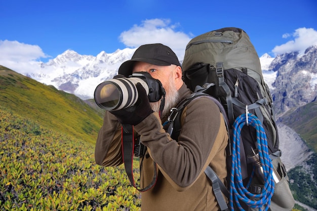 bearded man tourist photographer with a backpack photographs the beauty of nature