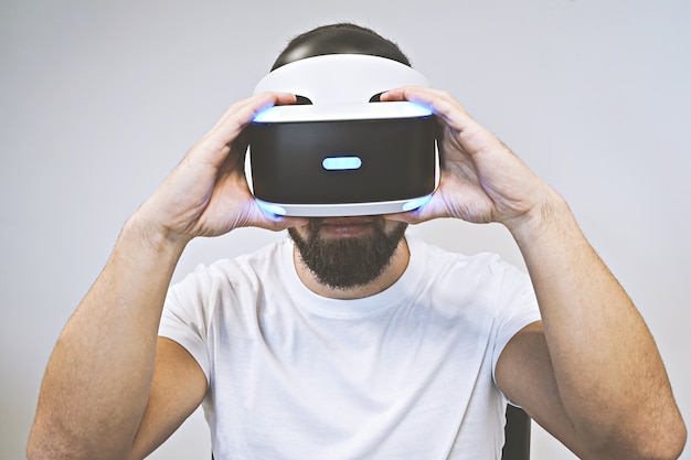 Bearded man uses 3D glasses and enjoys virtual reality