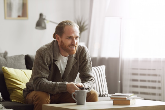 Bearded Man Watching TV at Home