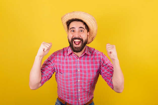 Bearded man wearing typical clothes for party Junina Celebrating cheering vibrating victory For the Arraia Party