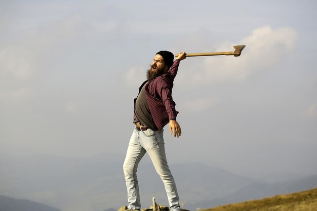 Bearded man with ax on mountain