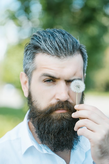 Bearded man with dandelion