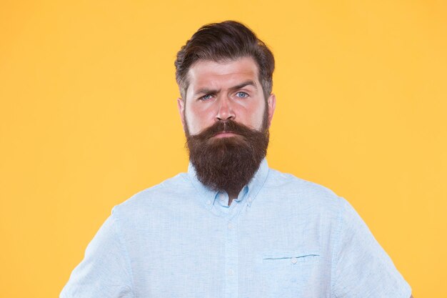 Bearded man with hairstyle in white shirt, male fashion.