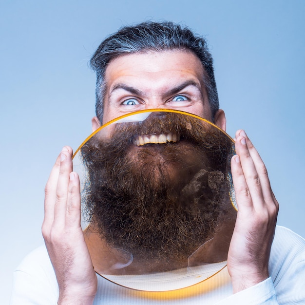 Bearded man with magnifying glass