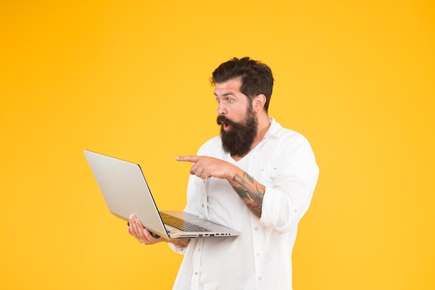 Bearded man with notebook. Online shopping. Man using notebook. Digital world. Programming concept. Programmer with laptop. Surfing internet. In search of inspiration. Online payment. Online purchase.
