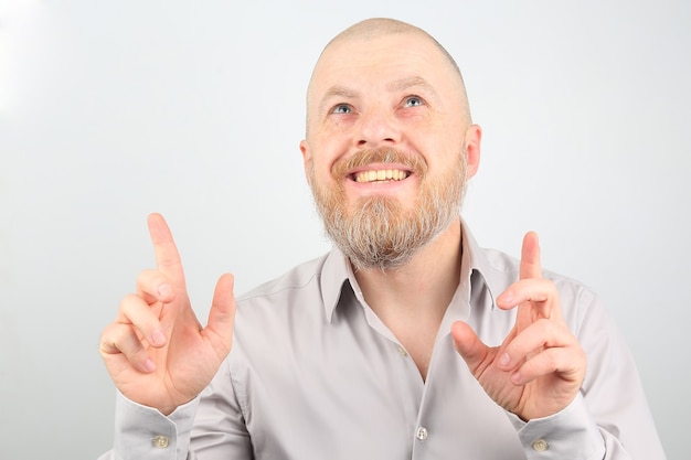 Bearded man with raised hands looking up