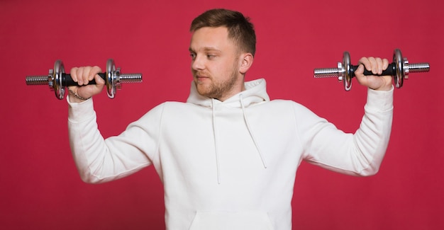 A bearded man with a red beard and mustache a blond man dressed in sportswear