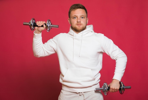 A bearded man with a red beard and mustache a blond man dressed in sportswear