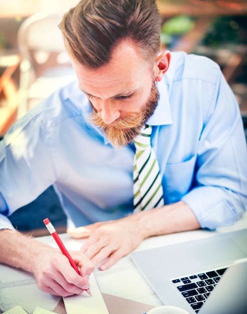 Bearded man working on a laptop