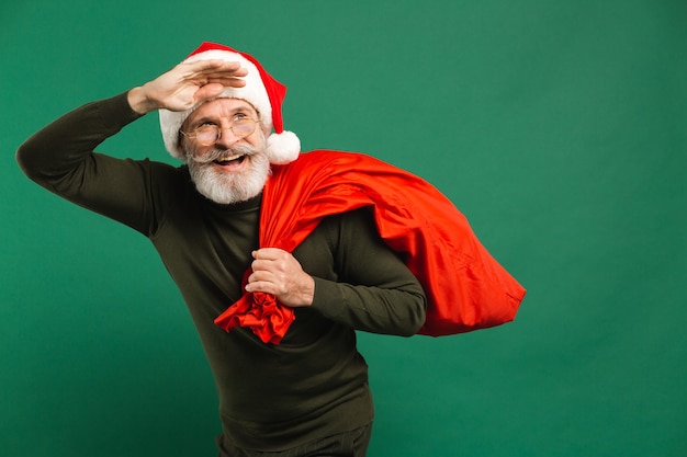 bearded modern Santa Claus holding red sack