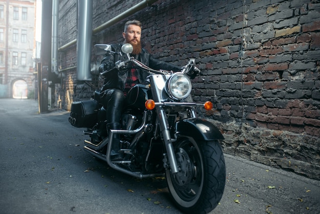 Bearded motorcyclist on classical chopper