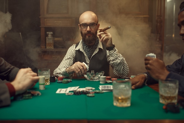 Bearded poker player with cigar, casino. addiction. Man leisures in gambling house