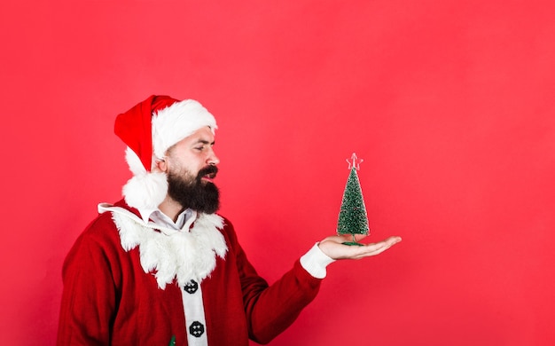 Bearded Santa man with little firtree Christmas tree Happy New Year man Sale and discount